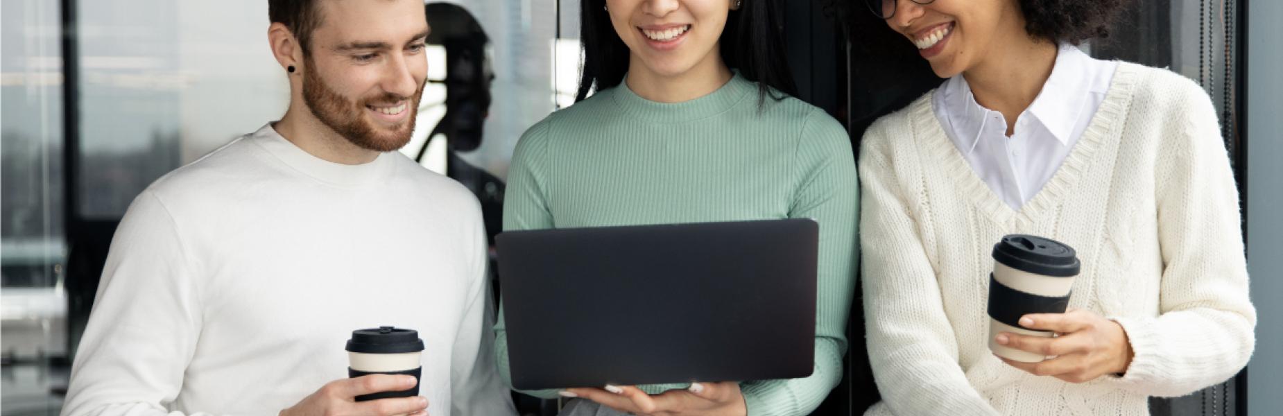 Three people looking at a laptop