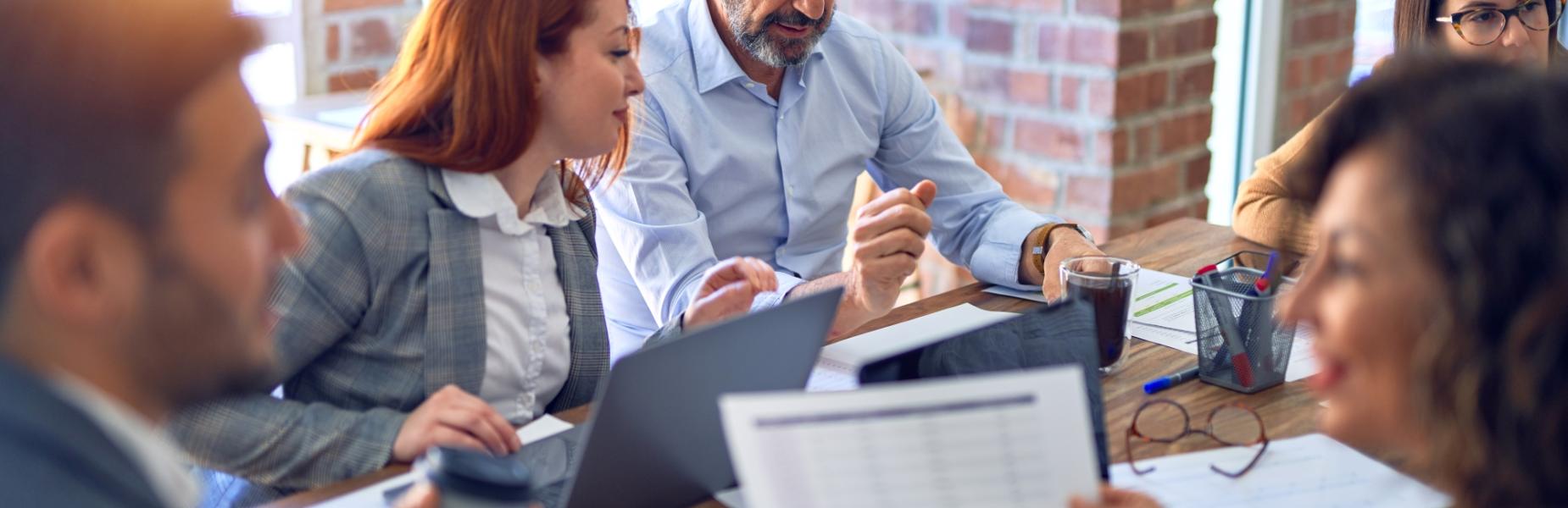 people sitting around a table in discussion