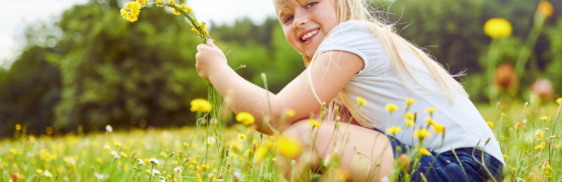 Girl with flowers in a meadow