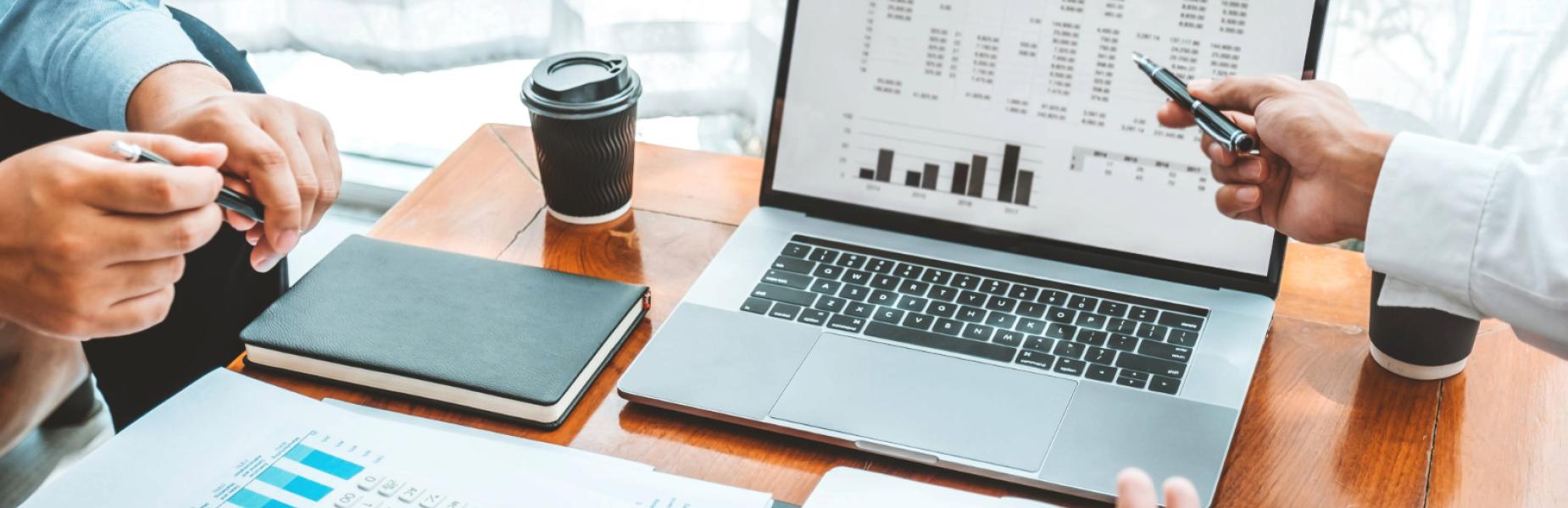 Laptop, calculator and papers on a desk