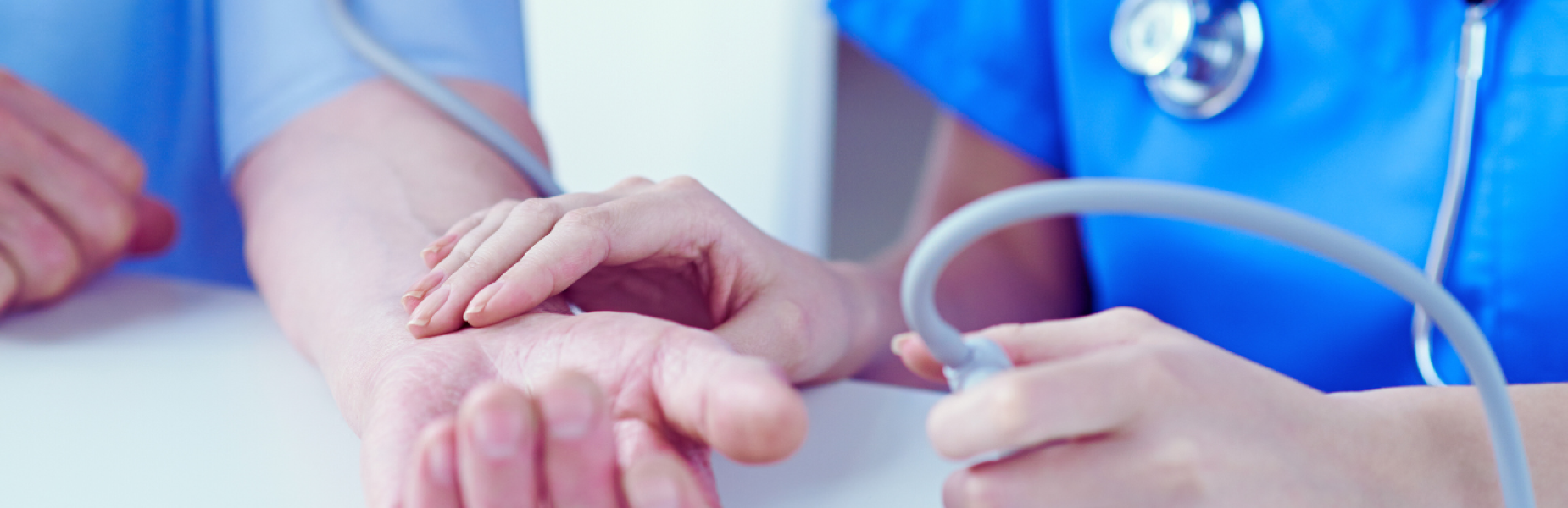 a nurse taking a patient's pulse