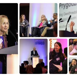 Llefarwyr a mynychwyr mewn cynhadledd broffesiynol, gyda thrafodaethau bwrdd, cyflwyniadau, ac ymgysylltu gyda'r gynulleidfa.